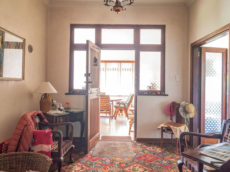 An entry foyer featuring a timber door with transom windows, providing access to the living area and outdoor space.