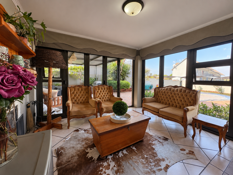 A bright living room featuring large glass sliding doors that provide ample natural light and direct access to the outdoor patio area.