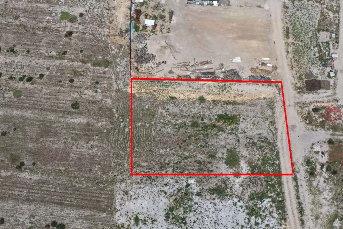 Aerial view of a vacant residential plot with clearly marked boundaries, suitable for future development.