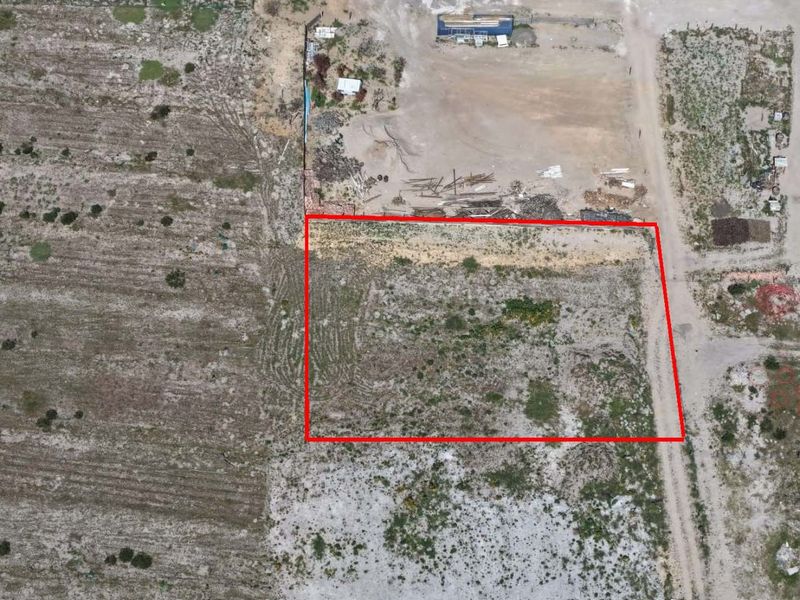 Aerial view of a vacant residential plot with clearly marked boundaries, suitable for future development.