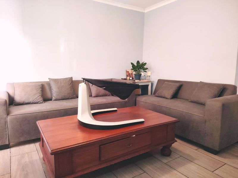 A living room featuring tiled flooring and coving, providing a neutral base for interior design updates.