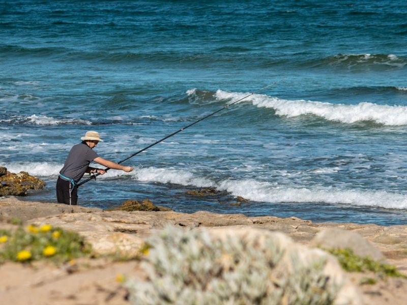 A scenic view of the coastline featuring rocky terrain and ocean waves, highlighting the natural landscape of the property location.