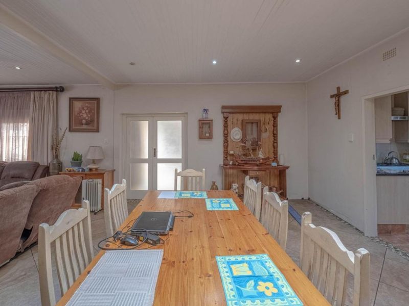 Open plan living and dining area featuring tiled floors, recessed lighting, and direct access to the kitchen area.