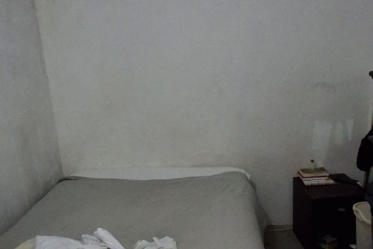 A bedroom space featuring plain walls and a ceiling, currently requiring cosmetic updates and maintenance to improve its overall condition.