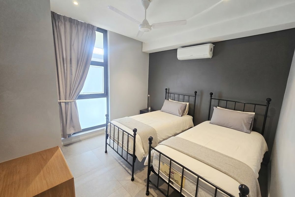 A modern bedroom featuring tiled flooring, a ceiling fan, and a wall-mounted split-system air conditioner.