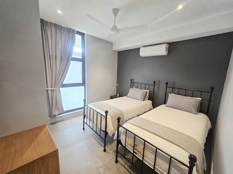 A modern bedroom featuring tiled flooring, a ceiling fan, and a wall-mounted split-system air conditioner.