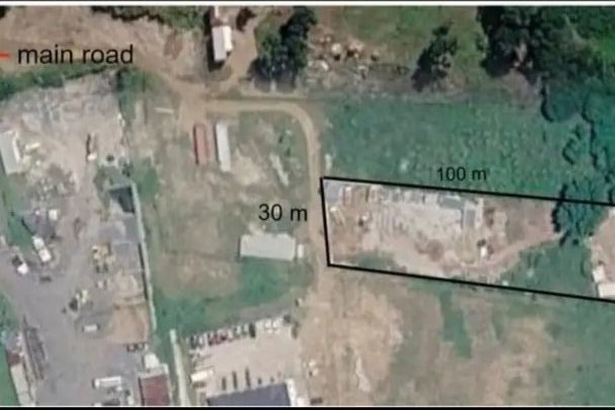 An aerial view showing the property plot dimensions and its proximity to the main road.