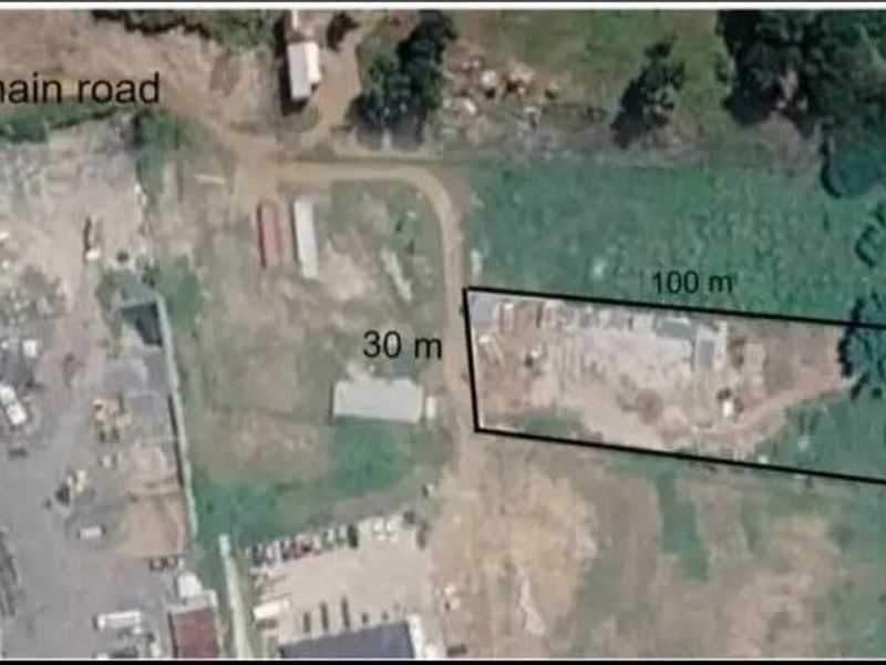 An aerial view showing the property plot dimensions and its proximity to the main road.