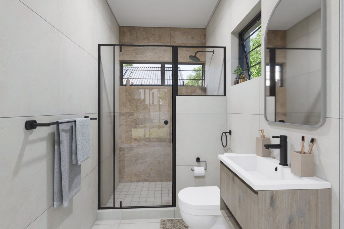 Modern bathroom featuring a walk-in shower with black-framed glass, a wall-mounted vanity with basin, and contemporary neutral tiling throughout.