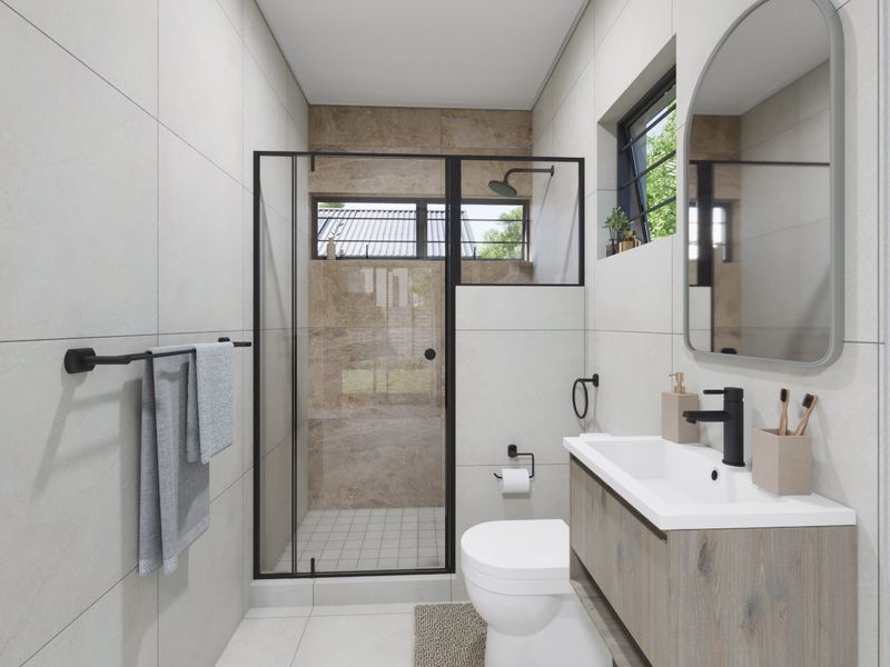 Modern bathroom featuring a walk-in shower with black-framed glass, a wall-mounted vanity with basin, and contemporary neutral tiling throughout.