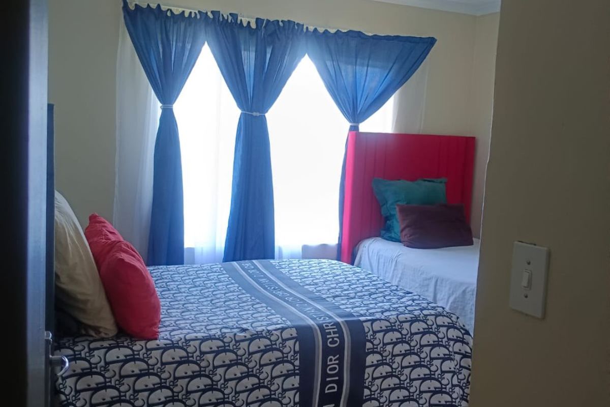 A bedroom featuring tiled flooring and a coved ceiling, viewed from the doorway.