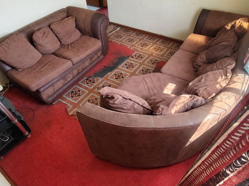 A living room area featuring patterned floor tiles and a red carpet, requiring updates to finishes to modernize the space.