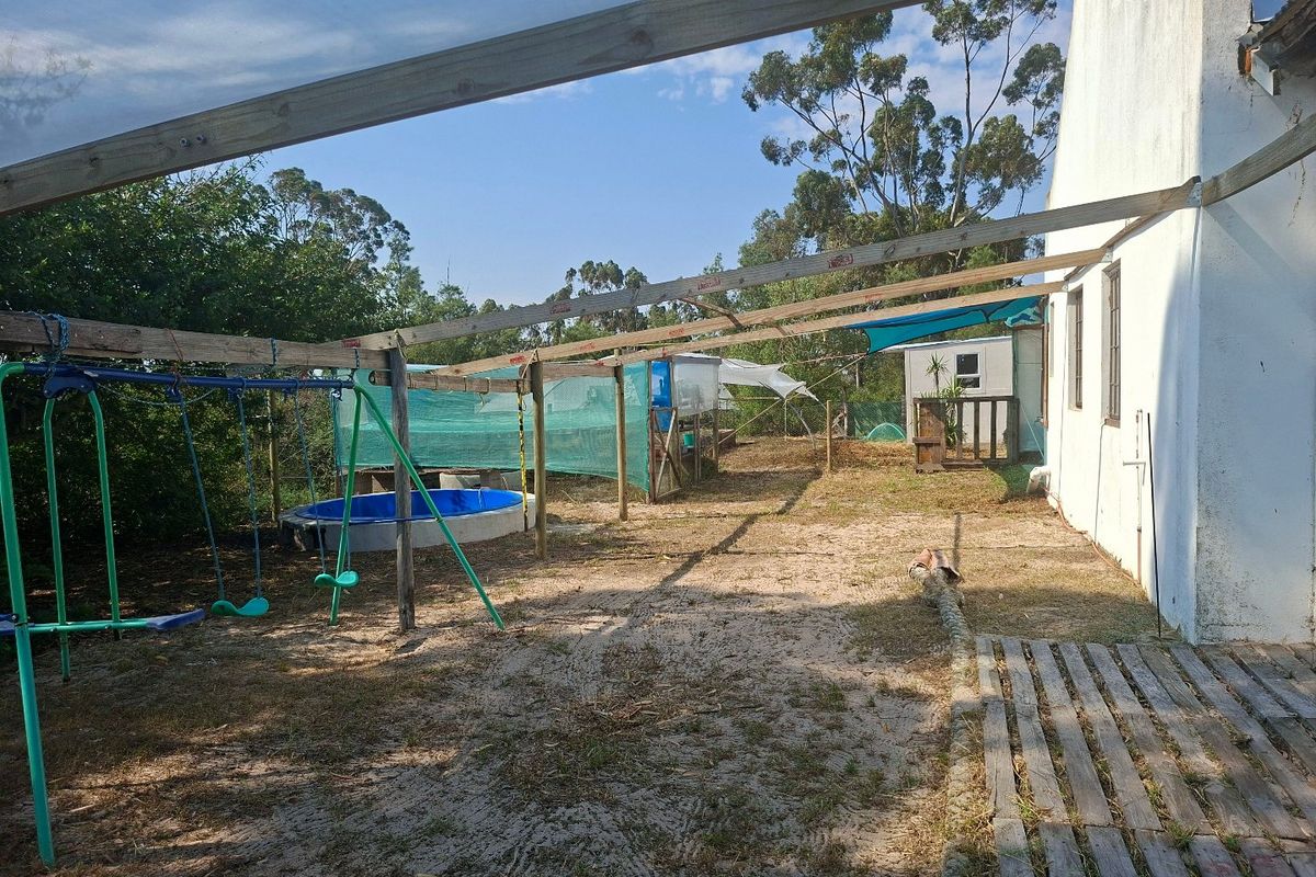 Rear exterior area featuring a timber pergola structure and direct access to the garden space.