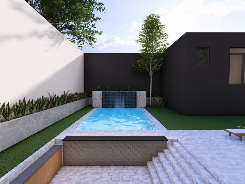 Modern outdoor pool area featuring a built-in water feature, tiled patio space, and landscaped garden borders.