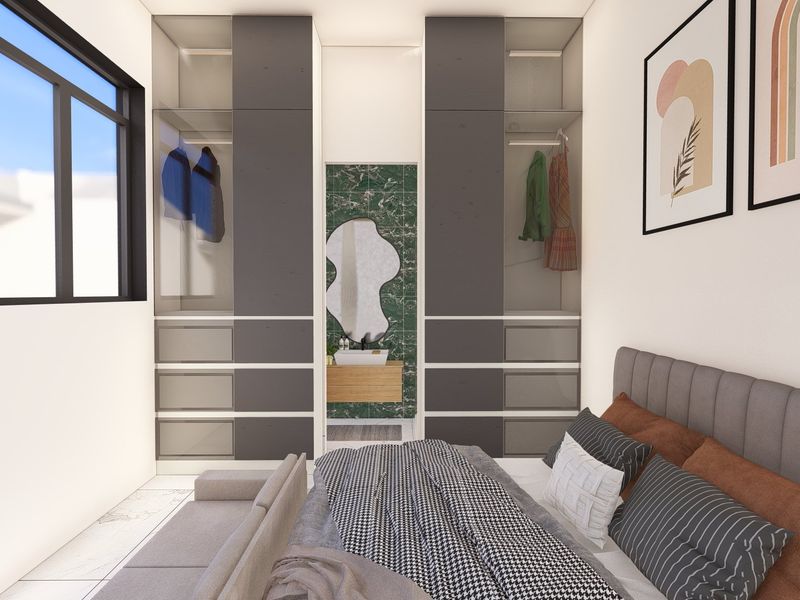 Modern bedroom featuring extensive built-in cabinetry, a sleek integrated vanity area with green marble-style tiling, and large windows for natural light.