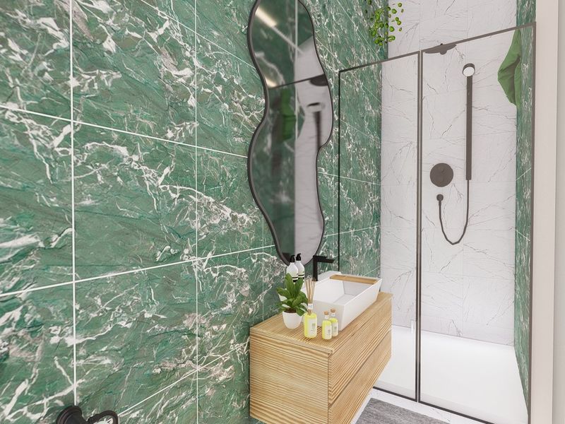 Modern bathroom featuring striking green marble-effect wall tiles, a sleek wall-mounted vanity with a vessel sink, and a contemporary walk-in shower.