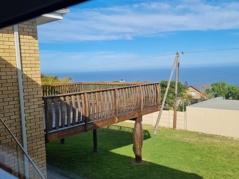 Elevated wooden deck overlooking the garden with expansive ocean views.