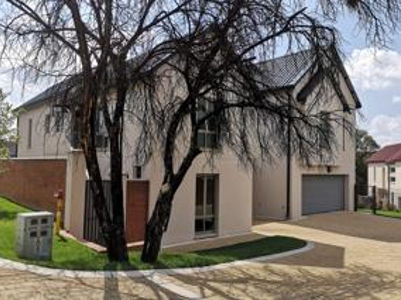 Front elevation of a modern double-story house featuring a paved driveway, double garage, and well-maintained exterior finishes.