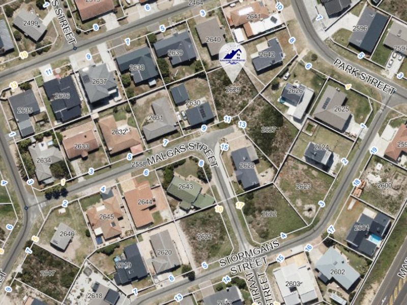 An aerial view of a residential neighborhood showing the layout of plots and street infrastructure.