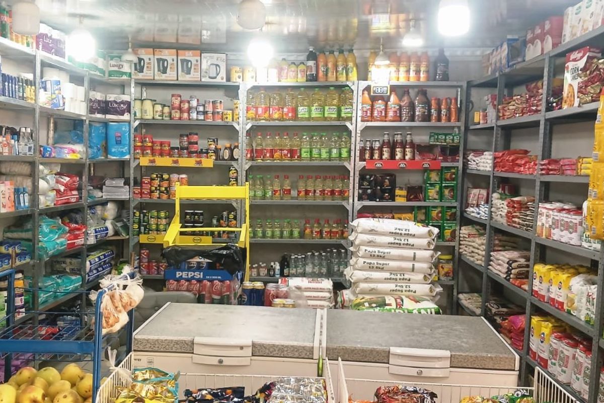 A commercial utility space or storage area featuring extensive metal shelving units and chest freezers for inventory management.