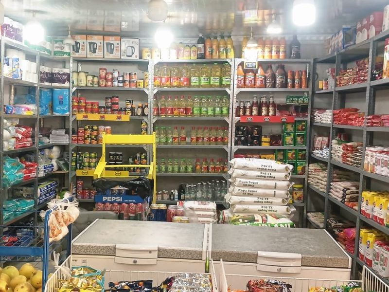 A commercial utility space or storage area featuring extensive metal shelving units and chest freezers for inventory management.