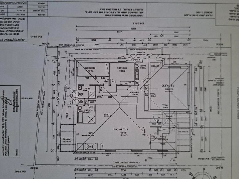 Architectural floor plan and site plan for a proposed new house, detailing room layout, boundary lines, and site dimensions.