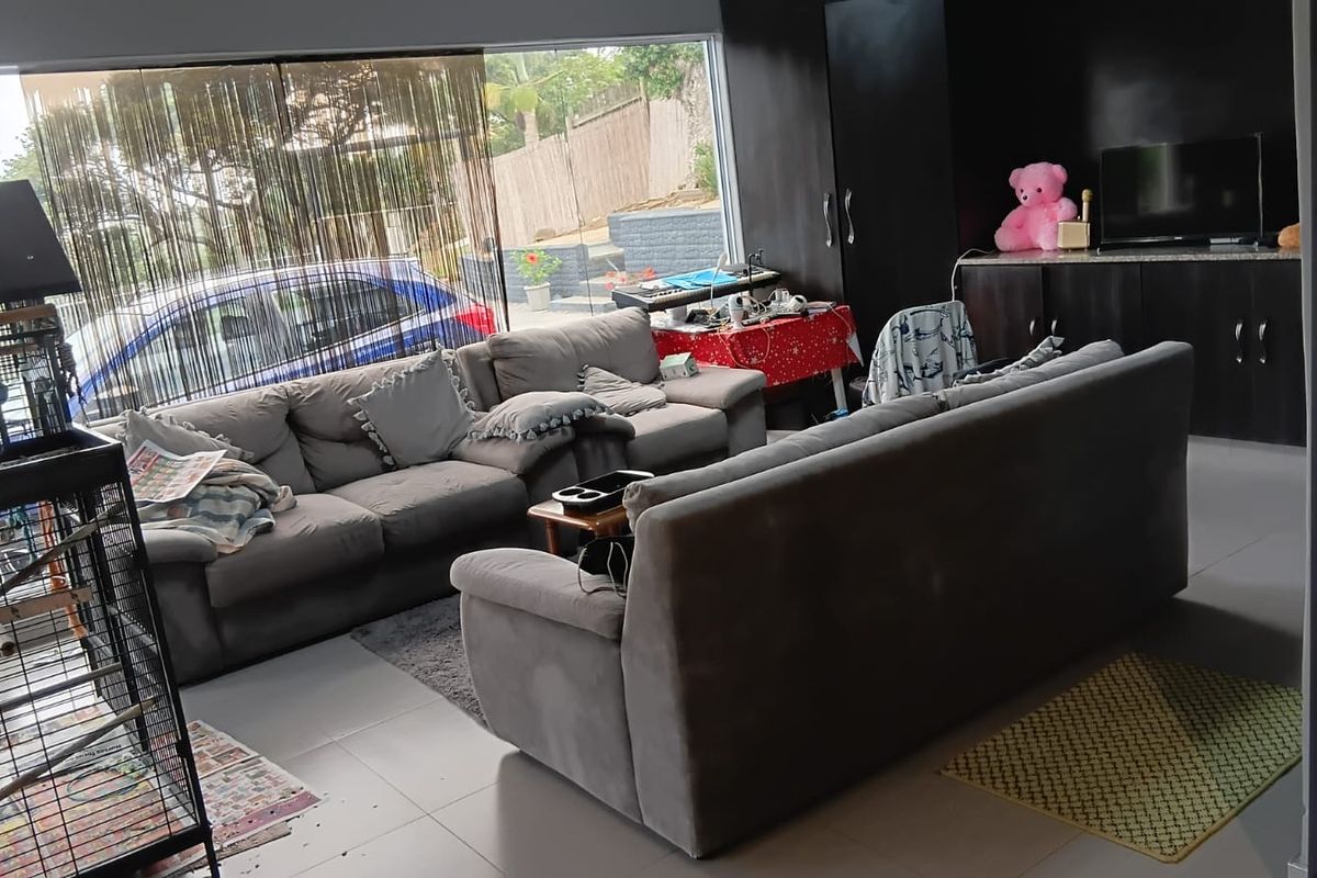 Spacious living room featuring large sliding glass doors for natural light and built-in cabinetry, providing a functional and open layout.