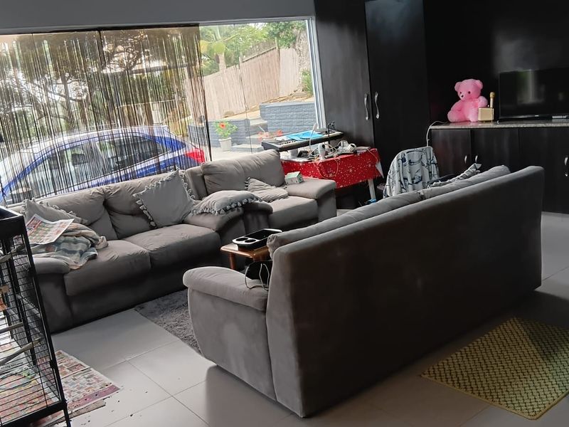 Spacious living room featuring large sliding glass doors for natural light and built-in cabinetry, providing a functional and open layout.