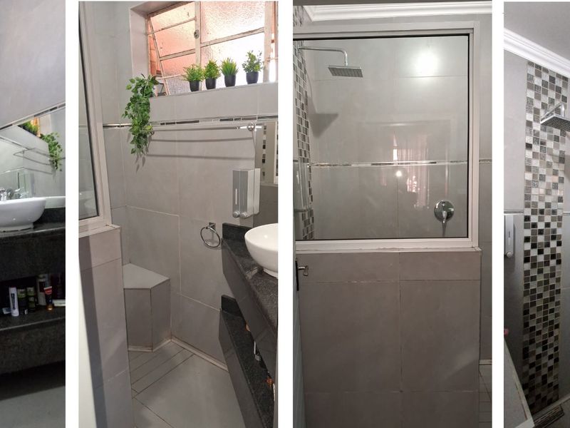 A modern bathroom featuring a vessel sink on a granite vanity, tiled walls, and a shower enclosure with a rainfall shower head.