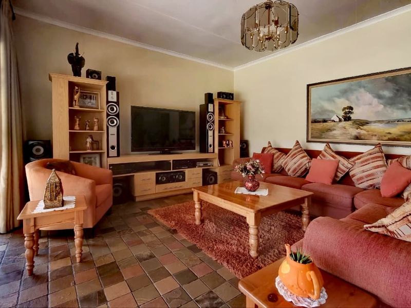 A comfortable living room featuring traditional slate tile flooring and a secure entrance gate, offering a warm and functional space.
