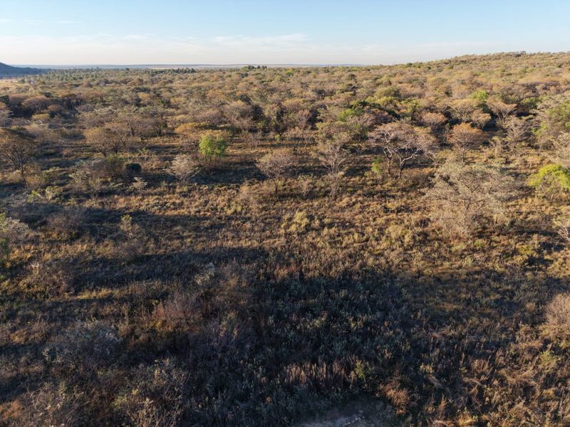 An aerial view of the expansive natural landscape and surrounding bushveld terrain.