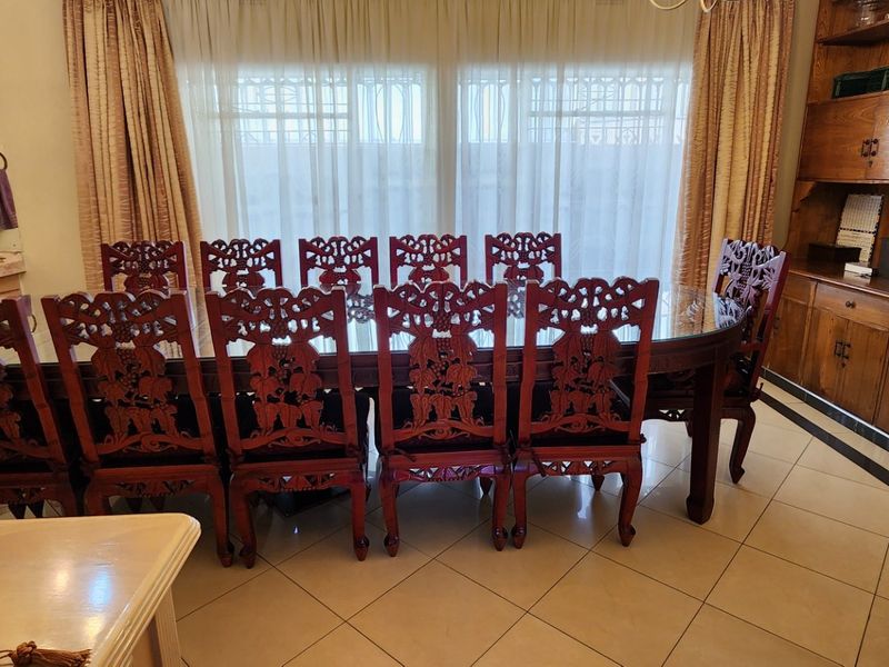 A formal dining room featuring tiled flooring and extensive built-in wooden cabinetry, providing ample storage and a classic aesthetic.