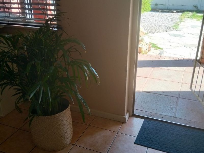 An entry area featuring tiled flooring and natural light, providing direct access to the outdoor patio space.