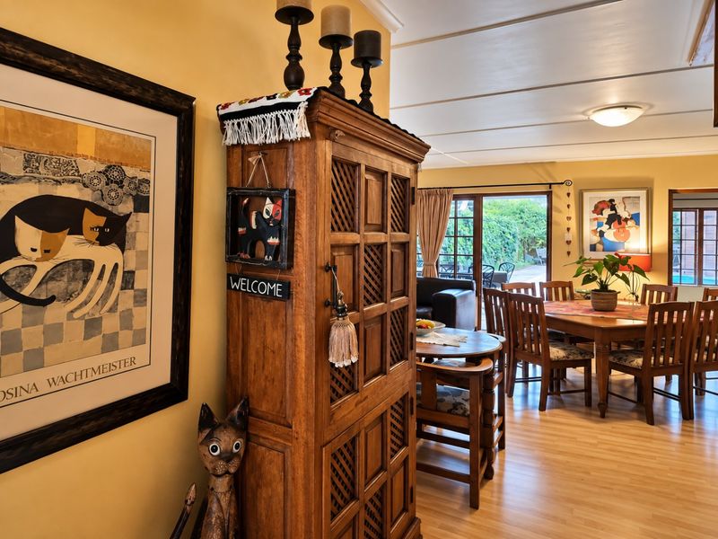 An open-plan living and dining area featuring laminate flooring and sliding glass doors that provide access to the outdoor patio space.