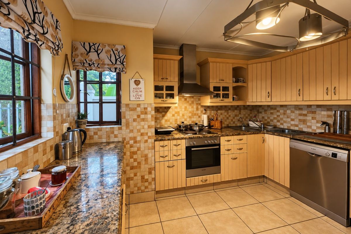A functional kitchen featuring timber cabinetry, granite countertops, a tiled backsplash, and integrated appliances including an oven, extractor fan, and dishwasher.