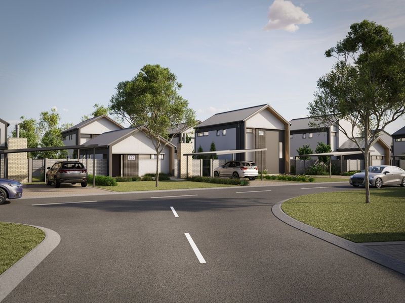 A street-level view of a modern residential development featuring contemporary homes with carports, paved driveways, and well-maintained landscaped surroundings.