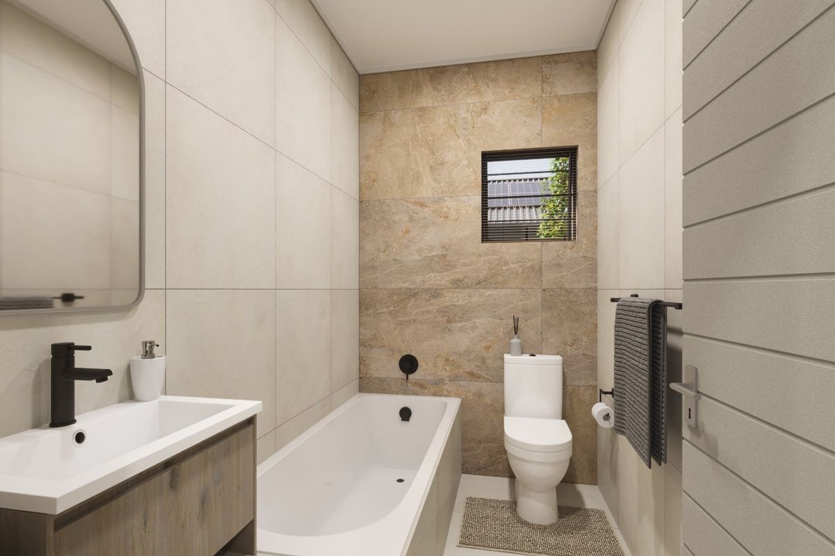 Modern bathroom featuring a built-in vanity, bathtub, toilet, and contemporary tiled finishes with neutral tones.