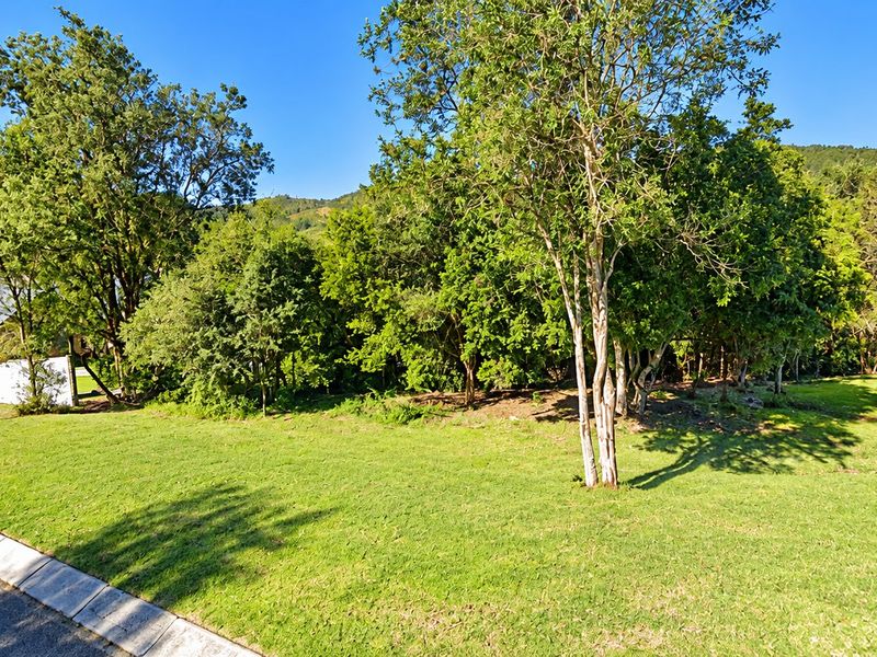 A well-maintained residential plot featuring established trees and a manicured lawn, offering a peaceful and scenic outdoor setting.