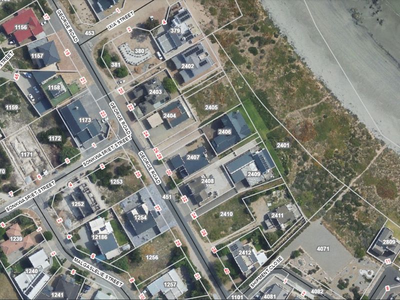 An aerial view showing the residential street layout, property plot boundaries, and proximity to the coastline.