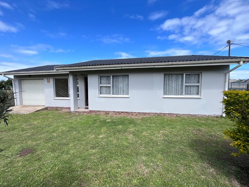 Front elevation of a single-story house featuring a tiled roof, single garage, and security-fitted windows, set on a grassed plot.