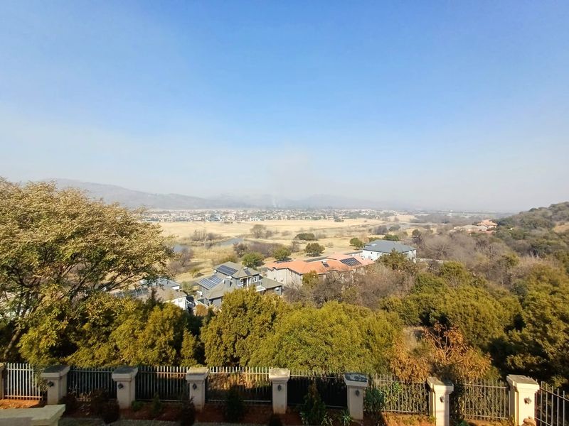 An elevated panoramic view overlooking the surrounding estate, landscape, and neighbouring residential properties.