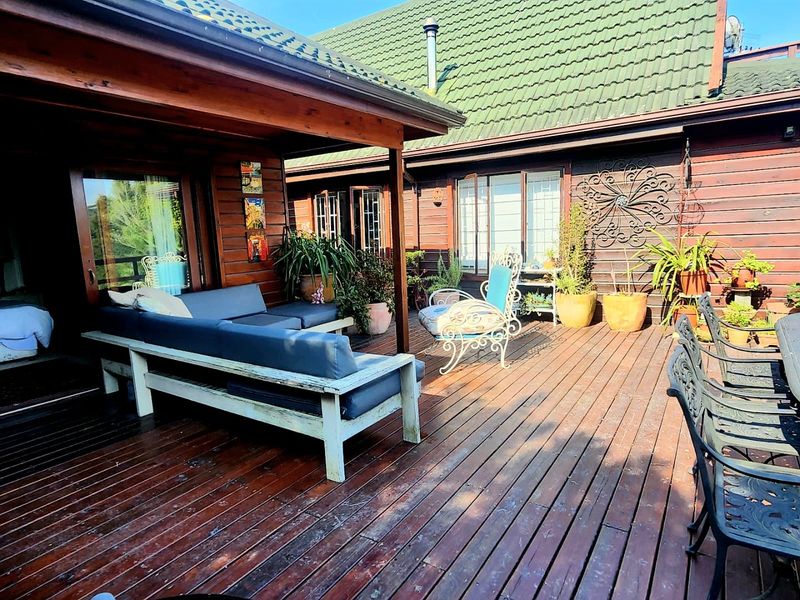 Spacious covered timber deck patio featuring natural wood cladding and direct access to the home, ideal for outdoor entertaining.