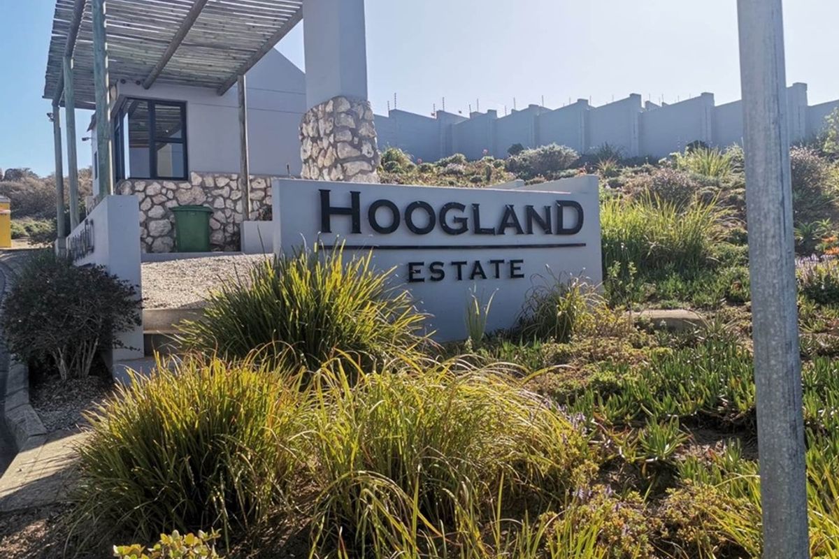 Entrance signage for Hoogland Estate featuring stone cladding details and a modern pergola structure.