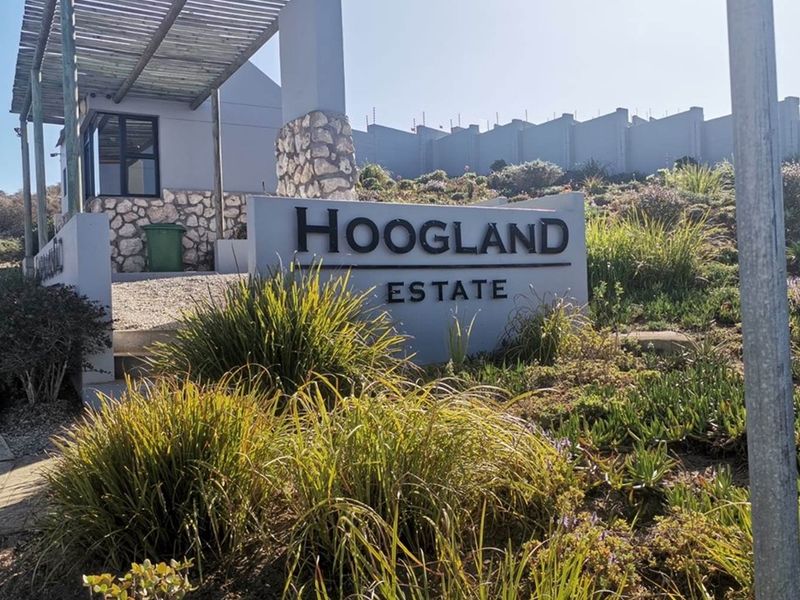 Entrance signage for Hoogland Estate featuring stone cladding details and a modern pergola structure.