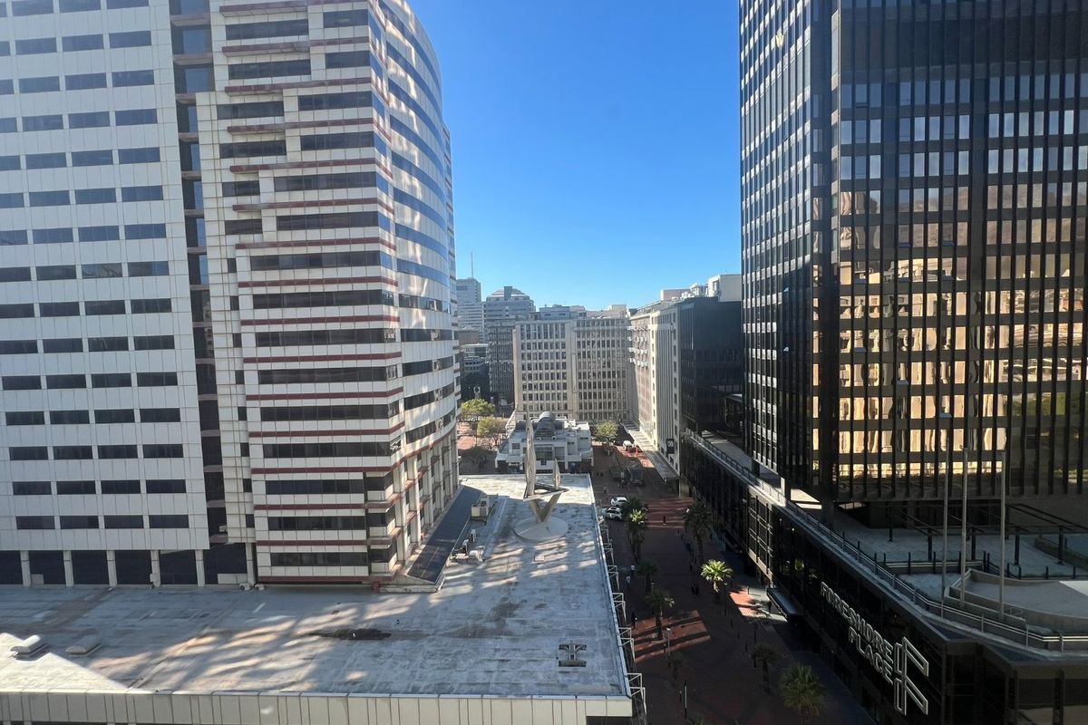 An elevated urban view looking out over the surrounding city skyline and streetscape from the apartment.