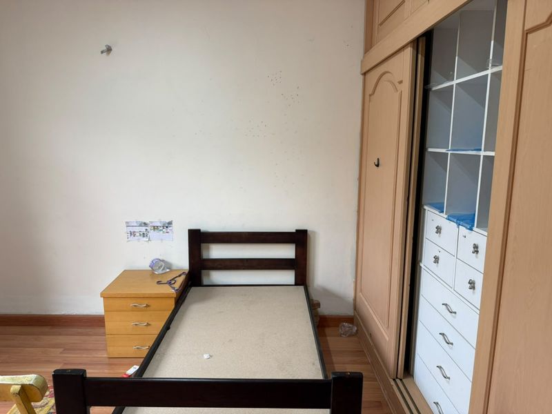 A bedroom featuring laminate flooring and a large built-in wardrobe with integrated shelving and drawers.