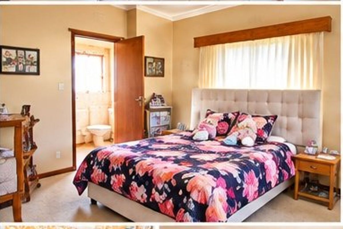 A bedroom featuring carpeted flooring, a timber window pelmet, and an adjoining en-suite bathroom.