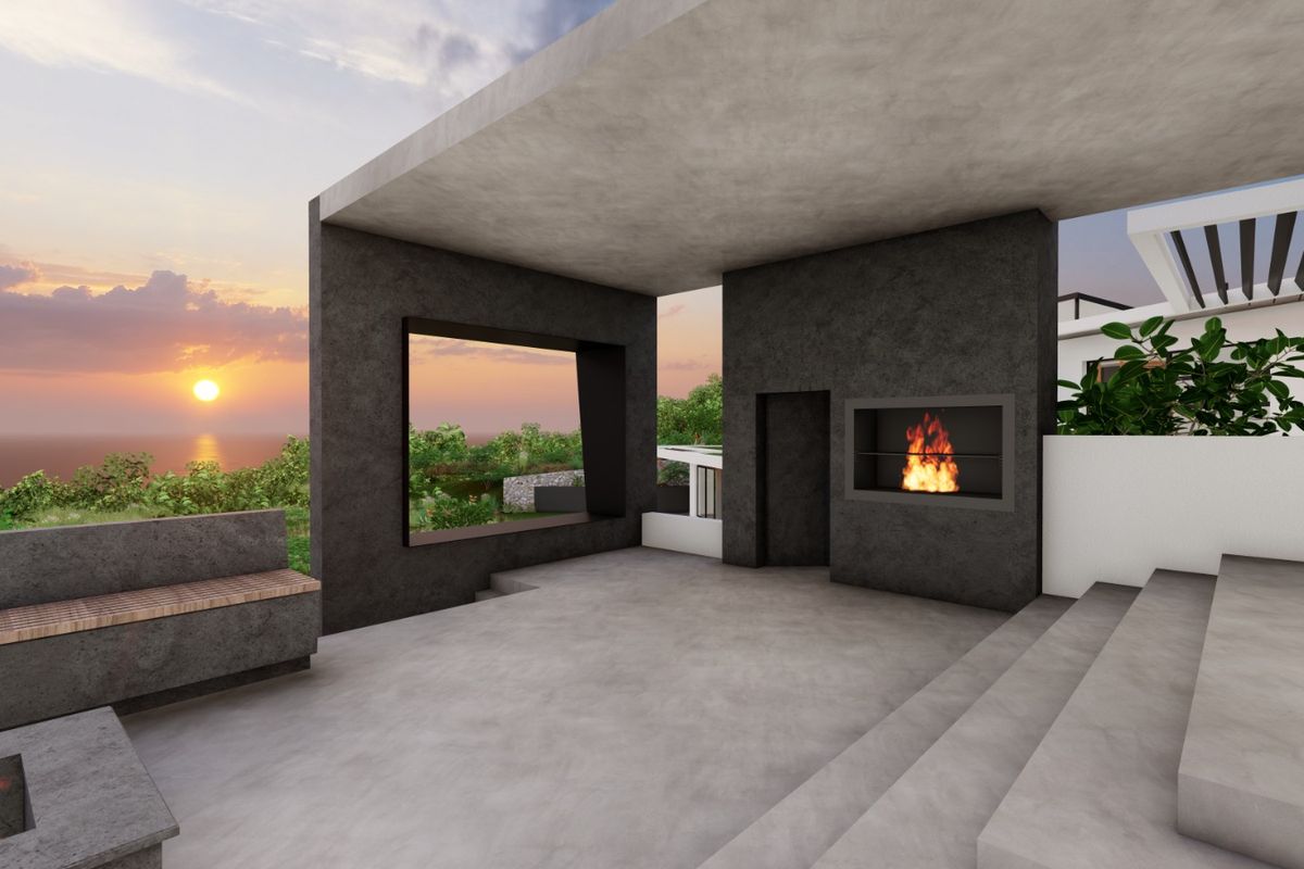 A modern covered patio featuring a built-in fireplace, concrete finishes, and panoramic sunset views, perfect for outdoor entertaining.