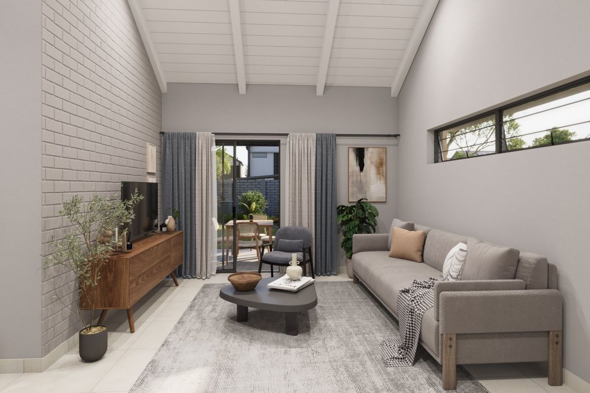 Modern living room featuring a high vaulted ceiling with exposed beams, a textured brick feature wall, and sliding doors leading to an outdoor patio area.