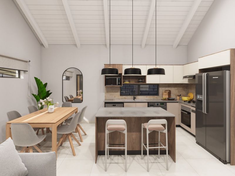 Modern open-plan kitchen and dining area featuring a central island, sleek cabinetry, stone countertops, and high-quality built-in appliances under an exposed beam ceiling.
